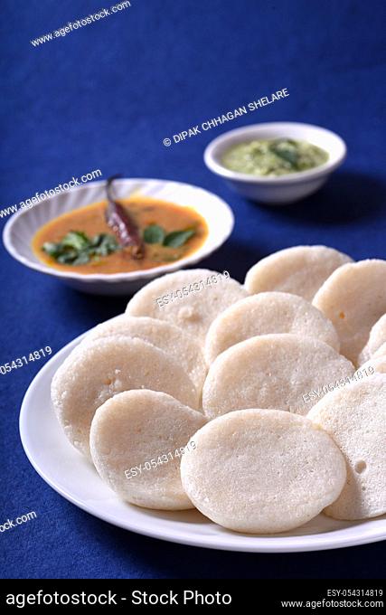 Idli with Sambar and coconut chutney on blue background, Indian Dish : south Indian favourite food rava idli or semolina idly or rava idly