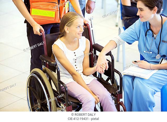Nurse and patient holding hands in hospital