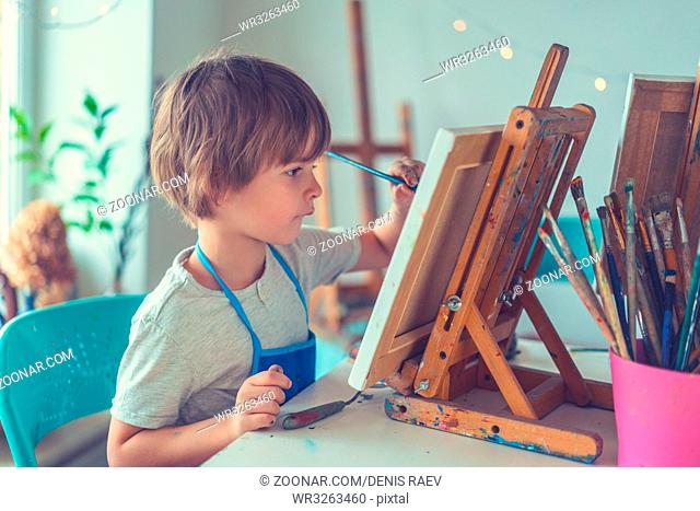 Little boy with an easel