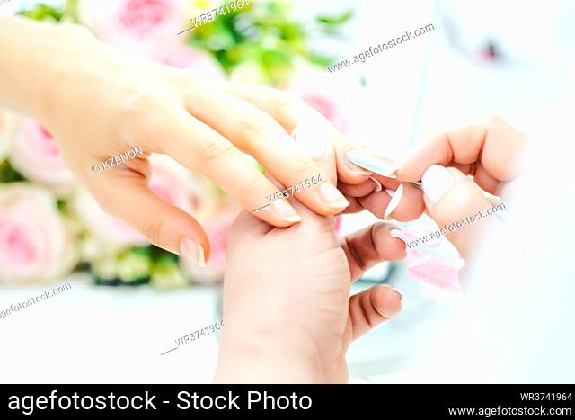 Woman having a manicure in beauty parlor