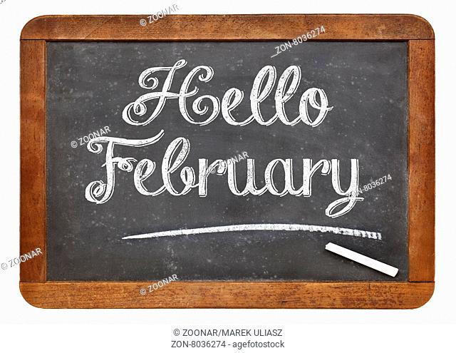 Hello February sign - white chalk text on an isolated vintage slate blackboard
