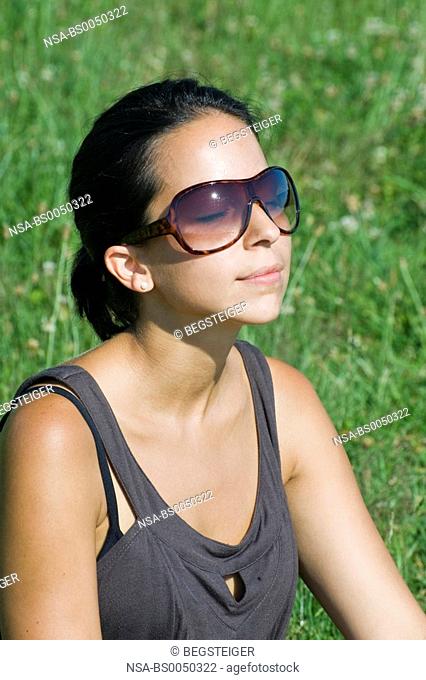 young woman relaxing in meadow