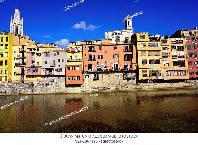 Buldings on the Onyar River. the tower of Sant Feliu Church on the left and the tower of the cathedral of Santa María de Girona on the right stand out behind...