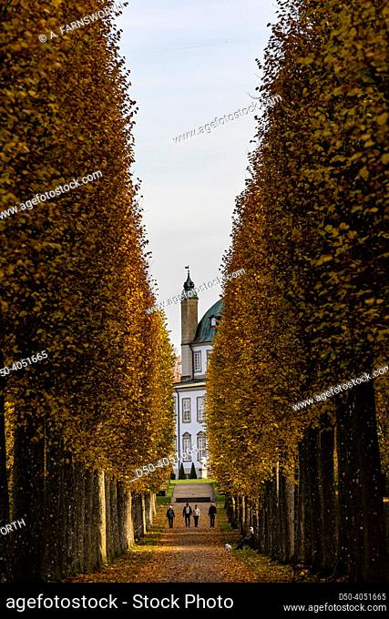 Fredensborg, Denmark, People walking through a landscape of trees in the autumn in the Royal baroque Gardens of the Fredensborg Palace