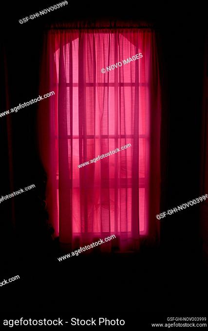 Daylight Streaming through Sheer Red Window Curtains