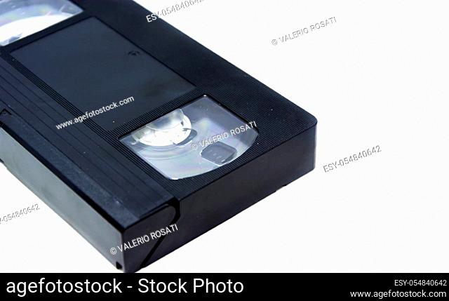 Detail of a VHS format videotape isolated on a white background. Home entertainment with movies. Analog video and audio data storage system