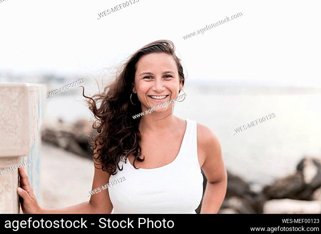 Smiling young woman enjoying at beach