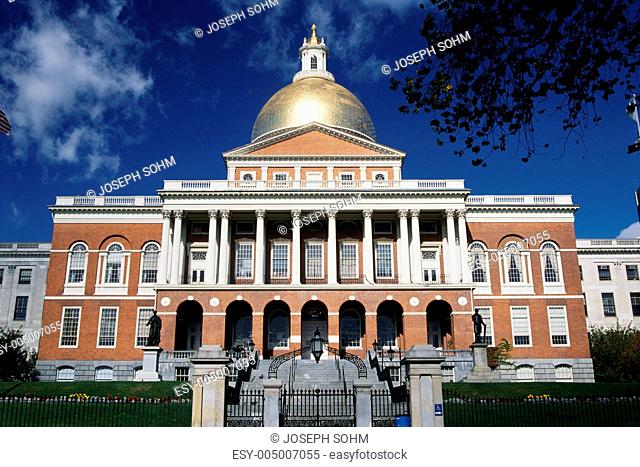This is the State Capitol building, also known as the State House. It has a gold dome with columns on its facade