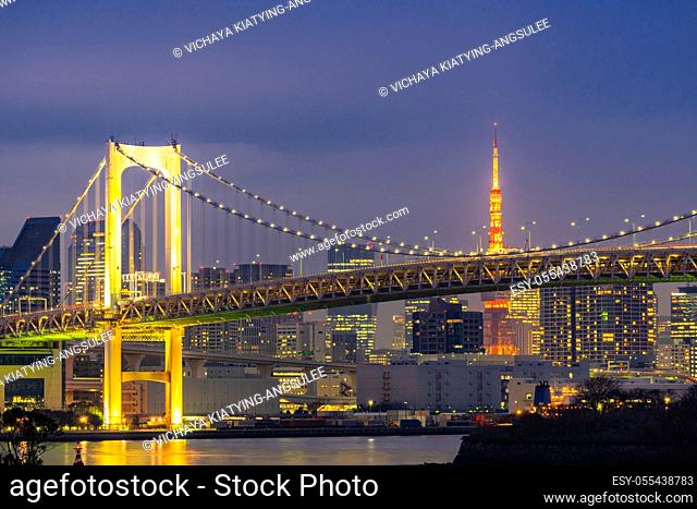 Tokyo Sunset with Tokyo tower and Rainbow bridge with Tokyo cityscape in background from Odaiba Japan