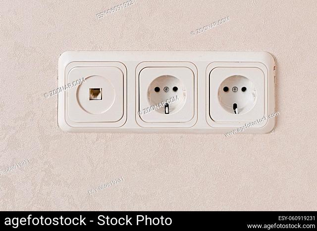 Two electric outlets on wall EU standart and telephone plug, copyspace