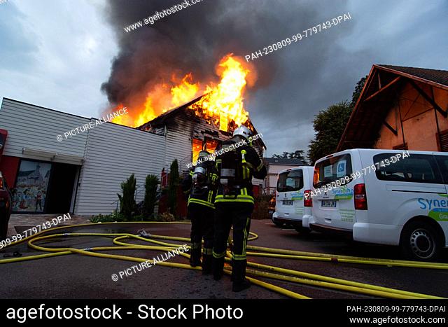 09 August 2023, France, Wintzenheim: Firefighters extinguish a fire in a vacation accommodation. Eleven people were missing after the fire
