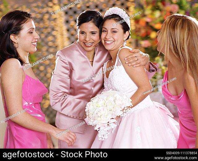 Bride posing for the camera with her mother
