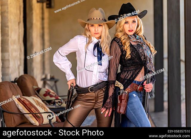 Two gorgeous blonde models dressed as cowgirls enjoying the outdoor weather