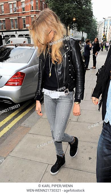 Cara Delevingne leaving her hotel wearing a leather biker jacket, circular sunglasses, grey skinny jeans and high top trainers Featuring: Cara Delevingne Where:...
