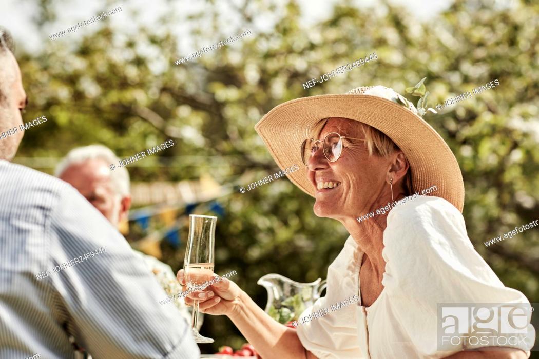 Stock Photo: Woman smiling at party in garden.