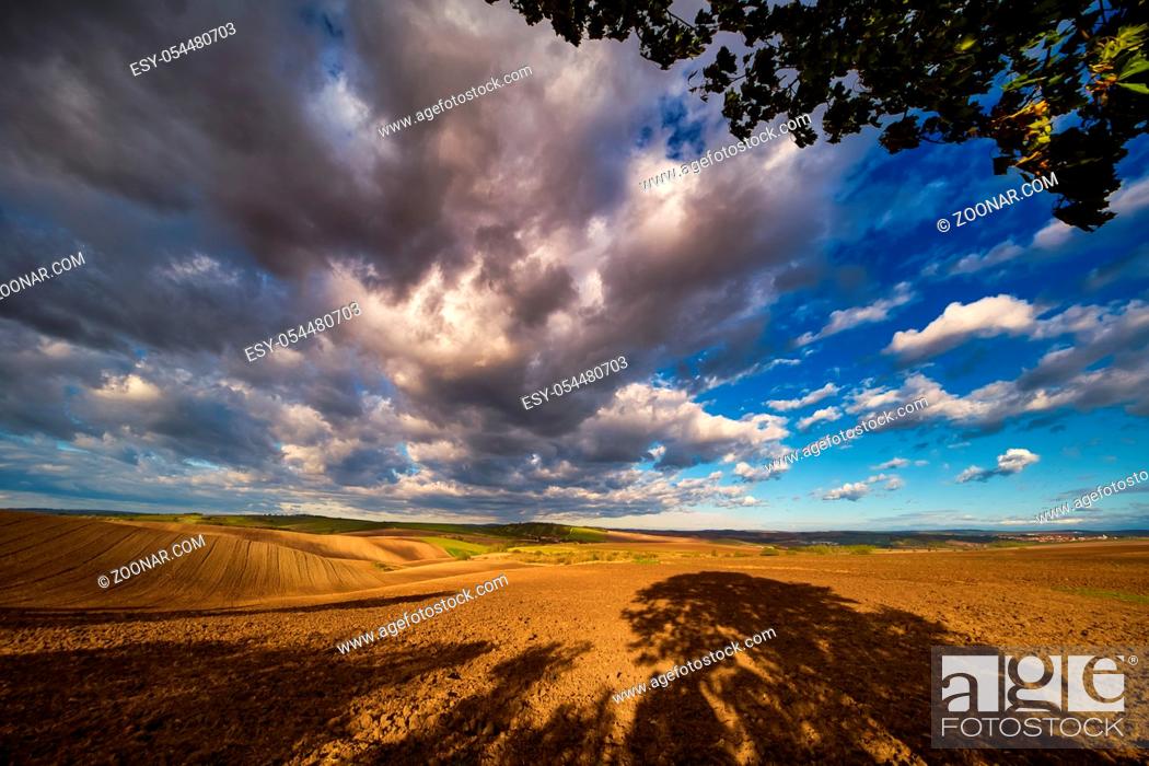 Stock Photo: Rolling fields of South Moravia in the autumn morning with a sky full of fast-moving clouds after a storm, Moravian Tuscany, Czechia.