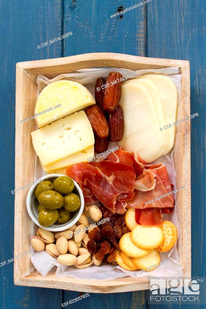 Stock Photo: cheese with prosciutto, bread, dry fruits.
